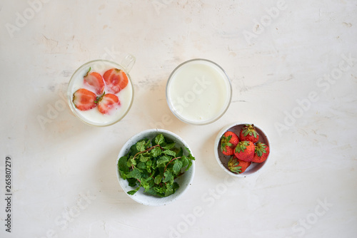 Fresh cream dessert with raw organic strawberry on white board. French style yogurt