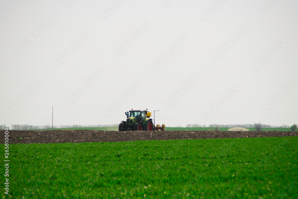 Tractor plows a field in the spring Tractor plows a field in the spring