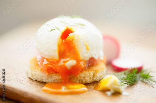 Poached egg sandwich with salmon, dill, radish, selective focus