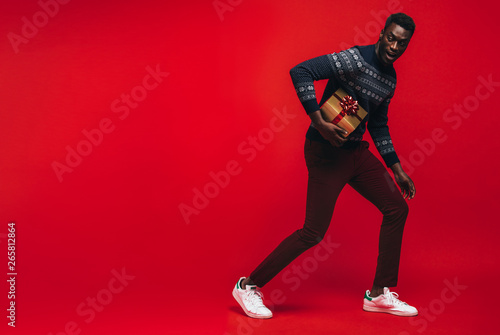 African american man running with a gift