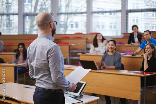 Lecturer and multinational group of students in an auditorium