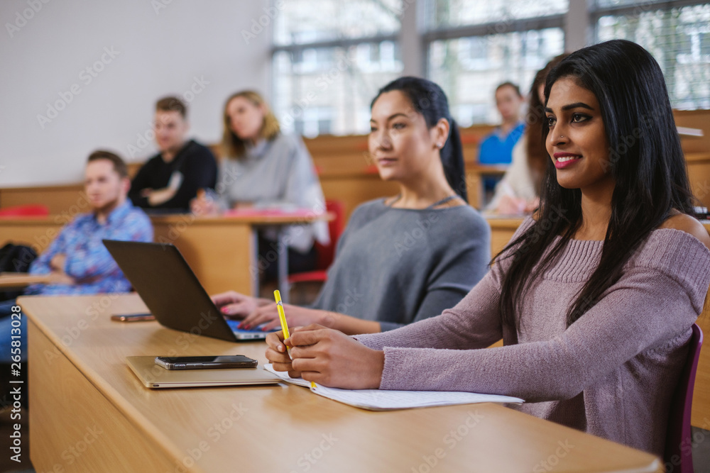 Multinational group of students in an auditorium Multinational group of students in an auditorium