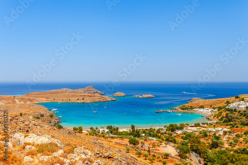 Sea skyview landscape photo Lindos bay and castle on Rhodes island  Dodecanese  Greece. Panorama with ancient castle and clear blue water. Famous tourist destination in South Europe