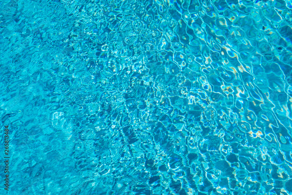 Blue ripped water in swimming pool. Surface of blue swimming pool, background of water in swimming pool. Water swimming pool texture and surface water on pool. Blue ripped water in swimming pool.