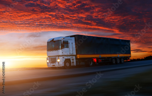 big White Truck on the Road in a Rural Landscape at Sunset.