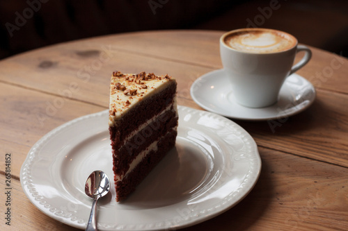 Cake and cup of coffee on a wooden desk table
