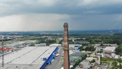 Amazing panoramic drone view of the industrial city in rainy day. Industry pipe with smoke polluting the air.