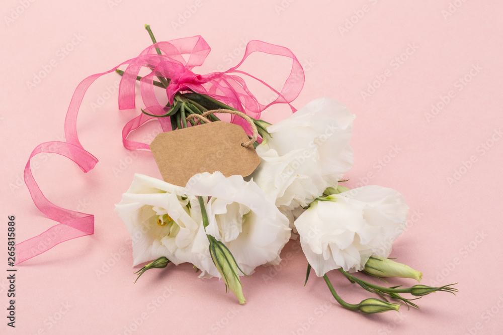 bouquet of white flowers on pink background