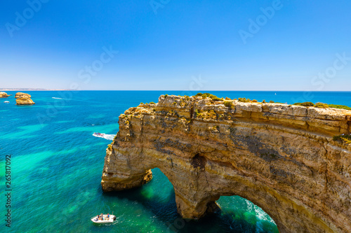 Natural caves at Marinha beach, Algarve Portugal. Rock cliff arches on Marinha beach and turquoise sea water on coast of Portugal in Algarve region. © daliu