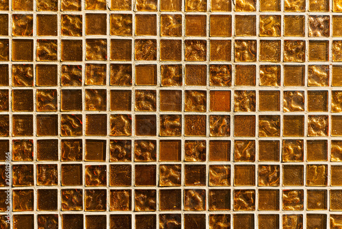 golden mosaic tile. a fragment of a wall with a mosaic of golden color © PsychoBeard