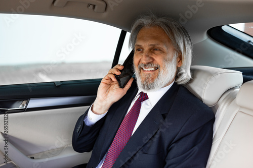 Senior businessman is driving in the car © Milana