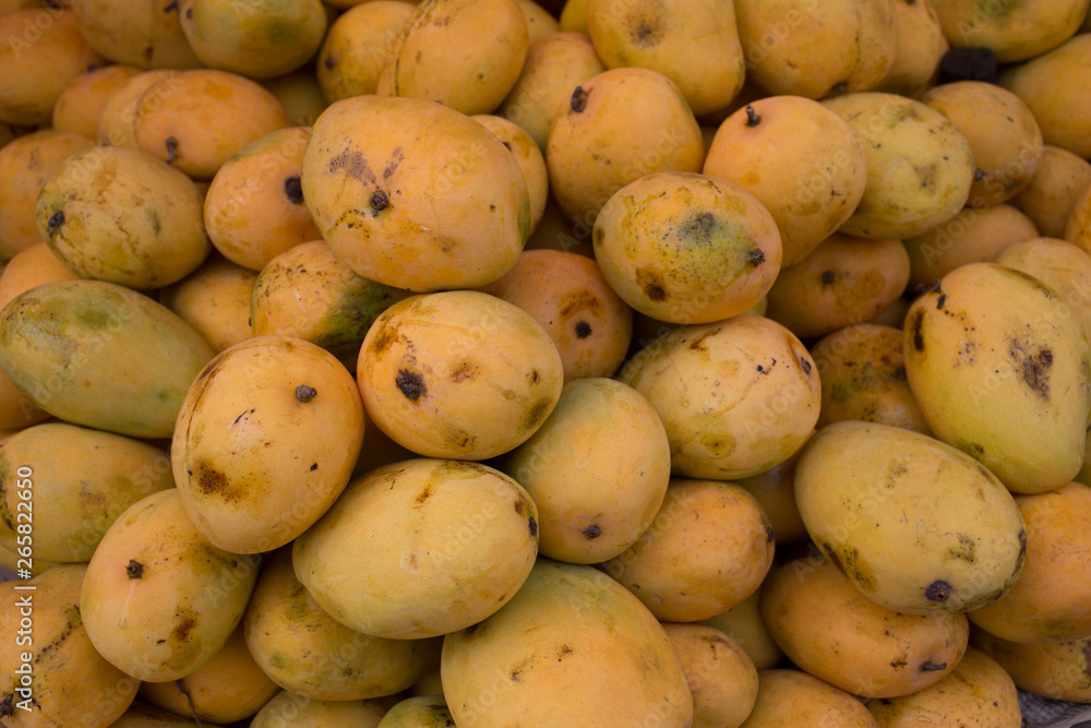 A heap of organic mangoes at a local market A heap of organic mangoes at a local market