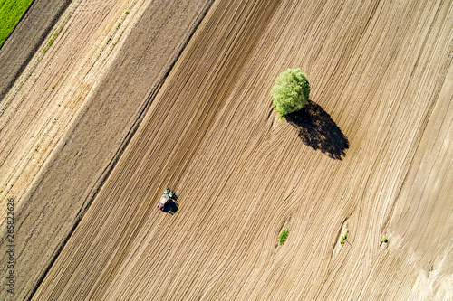 Trattore al lavoro in campo arato - vista aerea photo