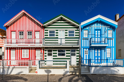 Street with colorful houses in Costa Nova, Aveiro, Portugal. Street with striped houses, Costa Nova, Aveiro, Portugal. Facades of colorful houses in Costa Nova, Aveiro, Portugal.