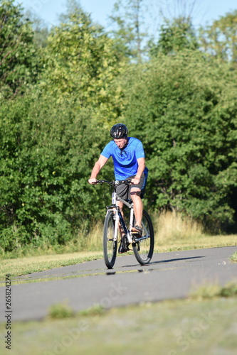 Adult Male Athlete And Loneliness Wearing Helmet Riding Bike