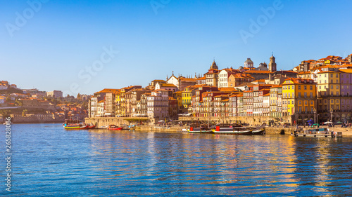 Colorful houses of Porto Ribeira, traditional facades, old multi-colored houses with red roof tiles on the embankment in the city of Porto, Portugal © daliu