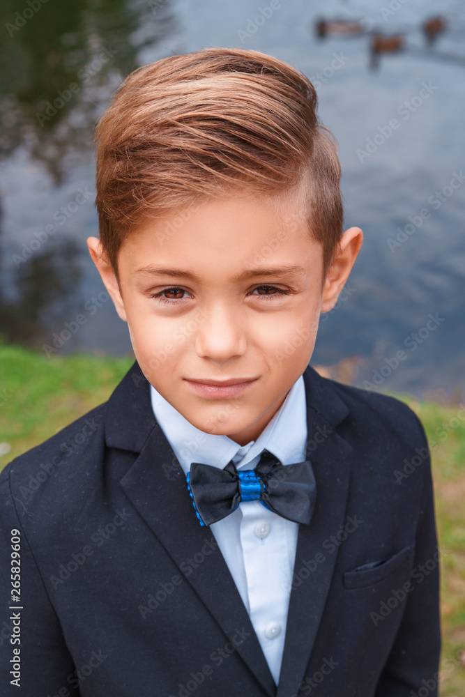 portrait of a boy in a suit in nature portrait of a boy in a suit in nature