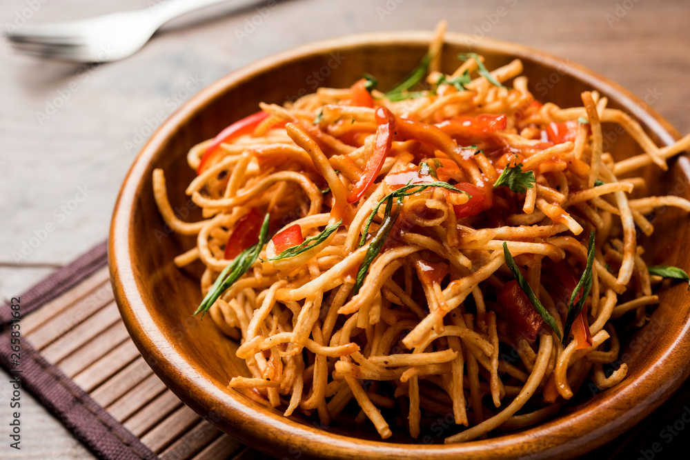 Chinese Bhel is a spicy indo-chinese recipe, served in a bowl. selective focus