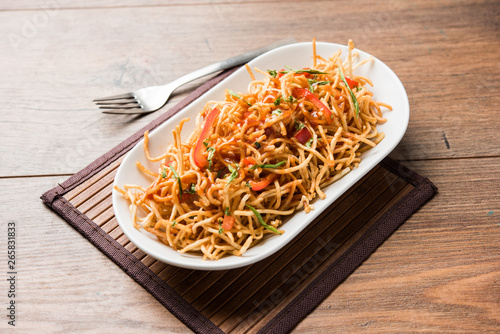 Chinese Bhel is a spicy indo-chinese recipe, served in a bowl. selective focus