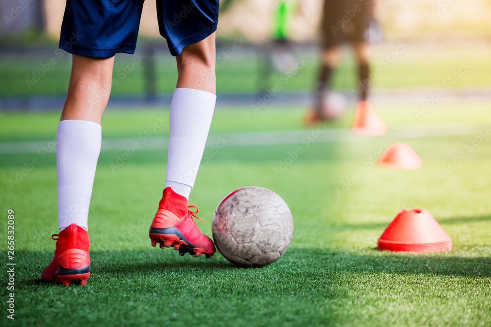 soccer player jogging and control ball between cone markers for soccer training soccer player jogging and control ball between cone markers for soccer training