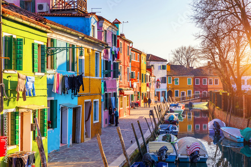 Laundry hanging out of typical houses of Burano Island, Venice, Italy. Multicolored buildings and laundry drying on the street in Burano, Venice, Italy