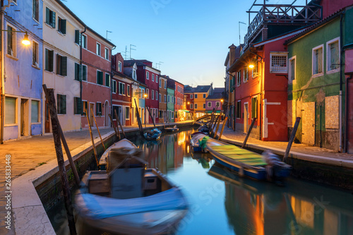 Street view with colorful buildings in Burano island, Venice, Italy. Architecture and landmarks of Burano, Venice postcard. Scenic canal and colorful architecture in Burano island near Venice, Italy © daliu