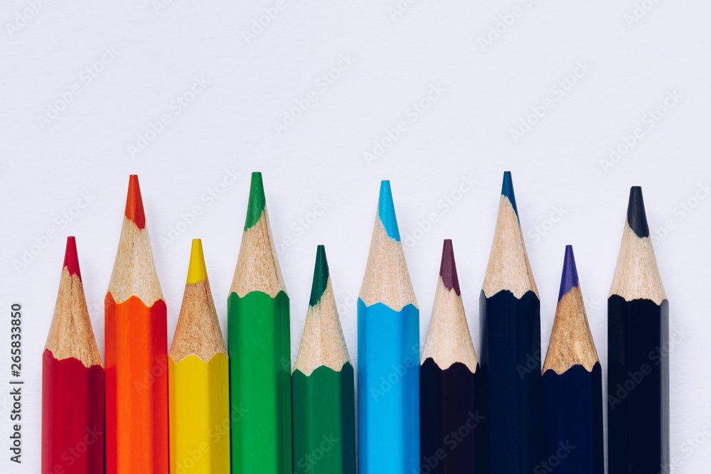 Color pencils isolated on white background. Close up of colored rainbow pencils for drawing, concept of preparing for school and discounts on stationery before the school year. Color pencils isolated on white background. Close up of colored rainbow pencils for drawing, concept of preparing for school and discounts on stationery before the school year.
