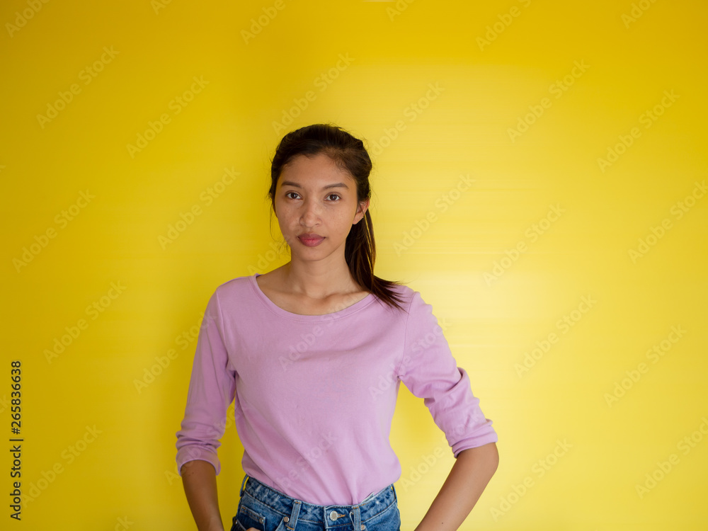 beautiful young asia woman against yellow wall. beautiful young asia woman against yellow wall.