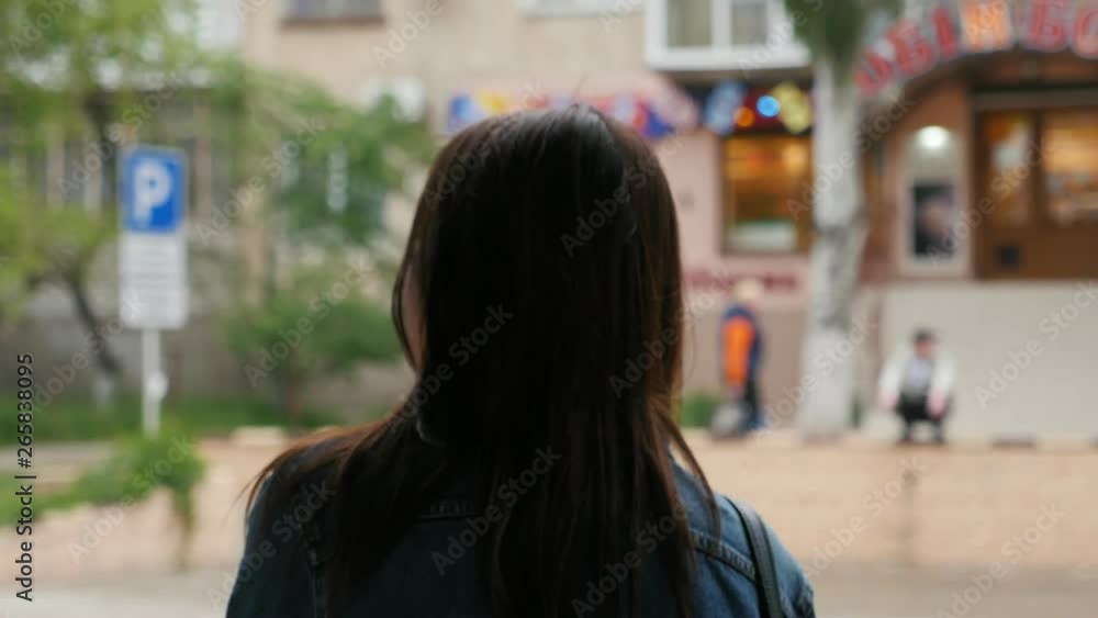 pensive caucasian girl waiting for a bus on the bus stop pensive caucasian girl waiting for a bus on the bus stop