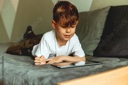 Boy playing with digital tablet