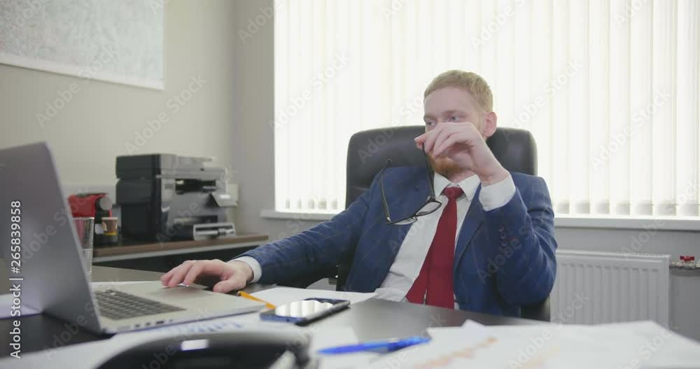 director works at computer and plays with glasses. director works at computer and plays with glasses.