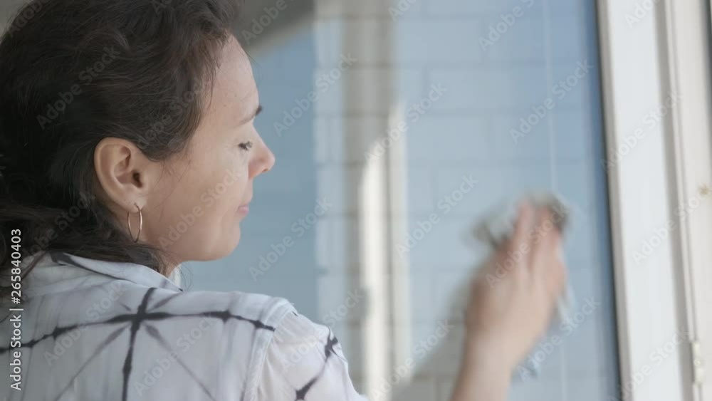 Washing windows. The woman washes the window. Washing windows. The woman washes the window.