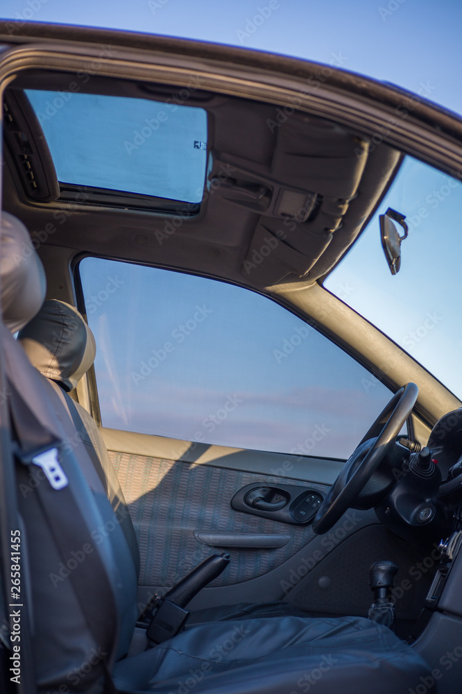 Salon inside the car, transmission with driver's steering wheel and ignition key