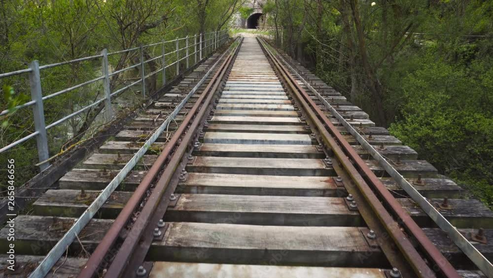 POV shot walking along a railway line. Old abandoned single track on rural countryside landscape . POV shot walking along a railway line. Old abandoned single track on rural countryside landscape .