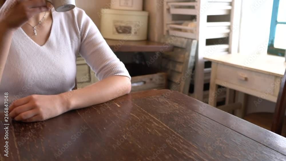 A beautiful woman drinking coffee and giving a sigh at home A beautiful woman drinking coffee and giving a sigh at home