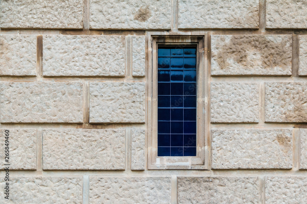 A window on the stone facade of the historic building front view closeup, Barcelona, Catalonia, Spain