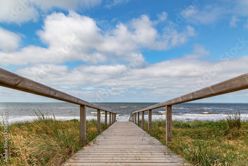 View to wooden path to access the Rantum Beach at Sylt / Germany photo