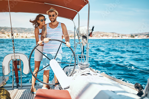 Young couple on a sailing boat -Romantic vacation and luxury travel.. © luckybusiness
