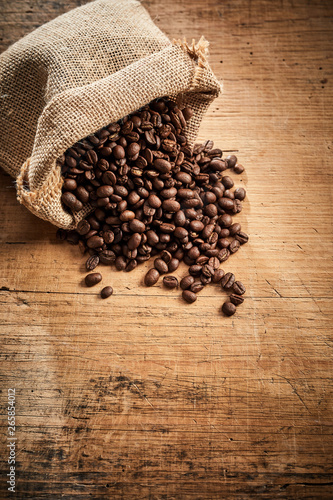 Full roasted blended coffee beans on rustic wood