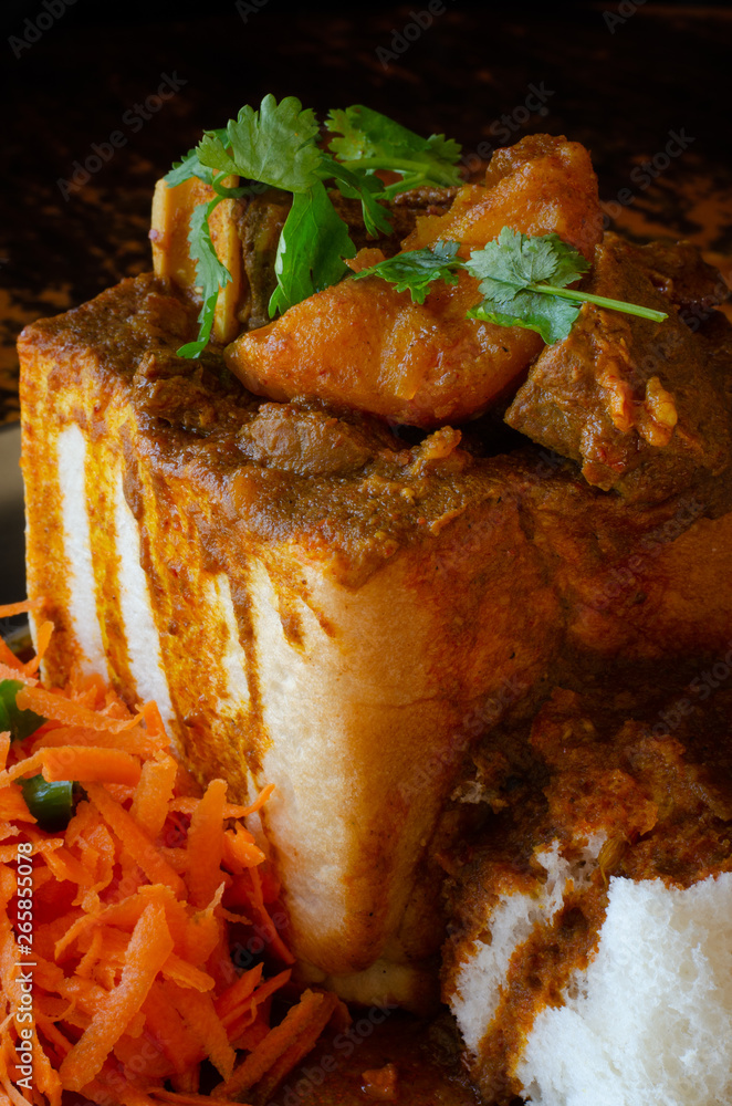 A Durban Bunny Chow or quarter mutton bunny served with sambals. This is an iconic Durban