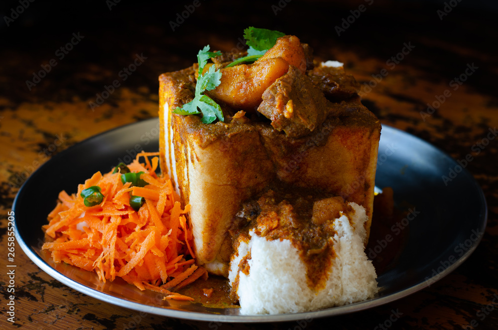 A Durban Bunny Chow or quarter mutton bunny served with sambals