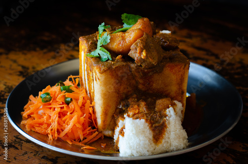 A Durban Bunny Chow - or quarter mutton bunny - served with sambals. This is an iconic Durban meal consisting of a section of a loaf of bread hollowed out and filled with mutton curry and gravy.