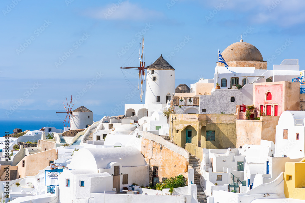 Traditional whitewashed architecture and windmills in Oia. Santorini, Greece