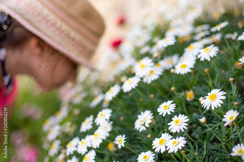 Child is smelling flowers