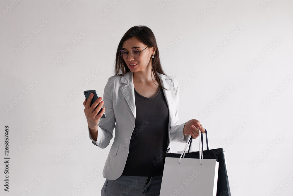shopping and making purchases at the store using credit card payments. Happy woman in glasses with several bags in their hands. shopping and making purchases at the store using credit card payments. Happy woman in glasses with several bags in their hands.