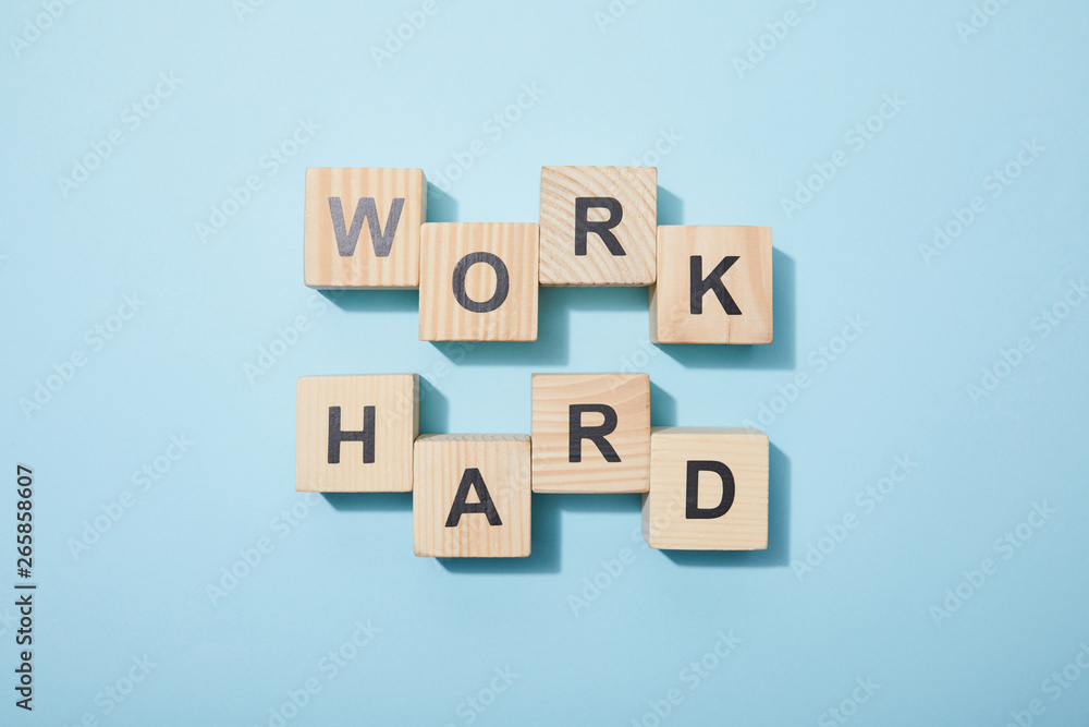 top view of wooden cubes with letters on blue surface top view of wooden cubes with letters on blue surface