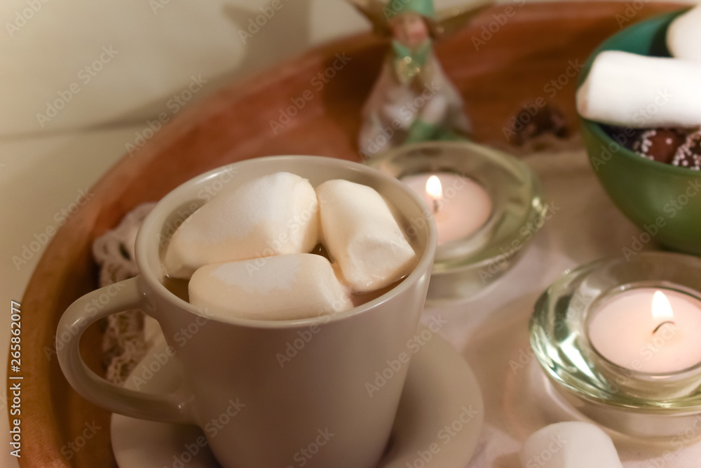 Christmas arrangement with sweets and cocoa. Sweets and marshmallows. Candles and angels. Christmas arrangement with sweets and cocoa. Sweets and marshmallows. Candles and angels.
