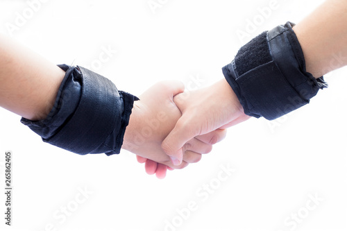 Human hands one of male and another one of female isolated on white wearing black colored wrist bands or wrist weights isolated on white.Doing various hand expressions to show unity and strength.