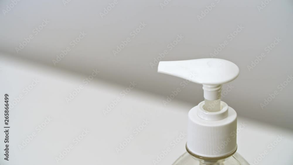 hand in green glove push dispenser and liquid detergent squeezed to yellow sponge hand in green glove push dispenser and liquid detergent squeezed to yellow sponge