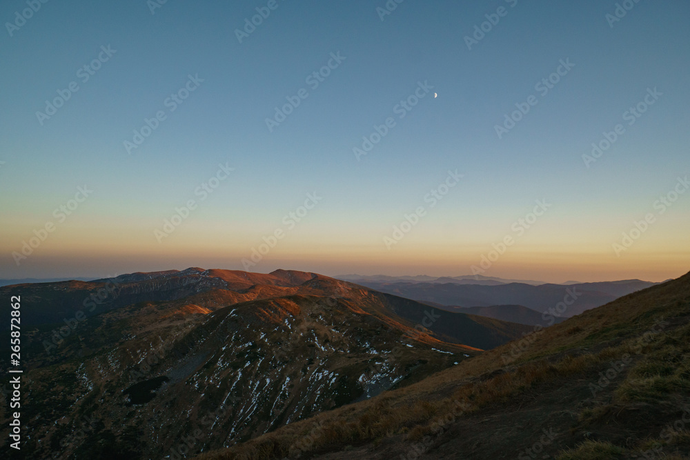 A little snow and moon above mountains sunset - landscape of the Ukrainian Carpathian Mountains, Chornohora A little snow and moon above mountains sunset - landscape of the Ukrainian Carpathian Mountains, Chornohora